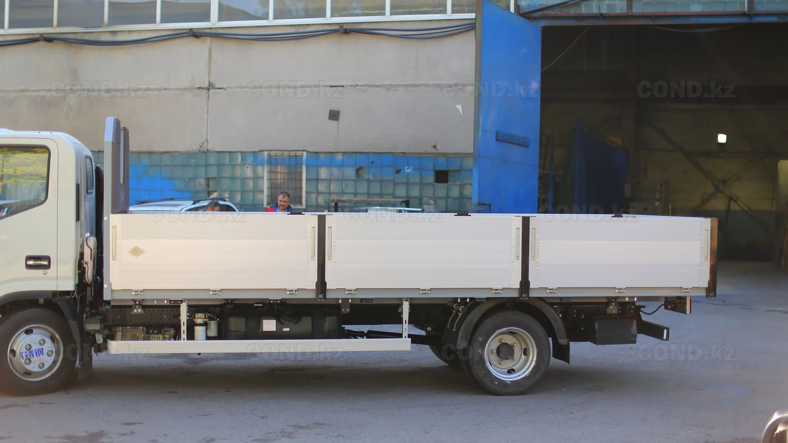 Flatbed platform on a JAC N56 chassis — the side boards folded down — COND