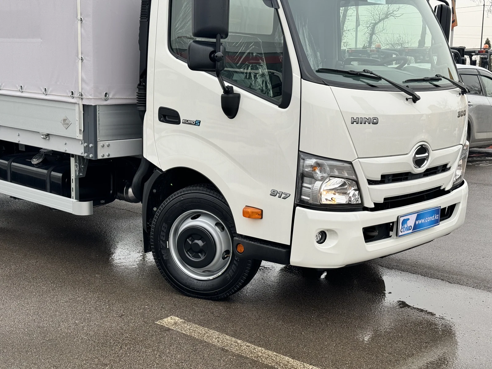 Curtain-side drop-side on a HINO 300 chassis — front 3/4 and the tilted side — COND