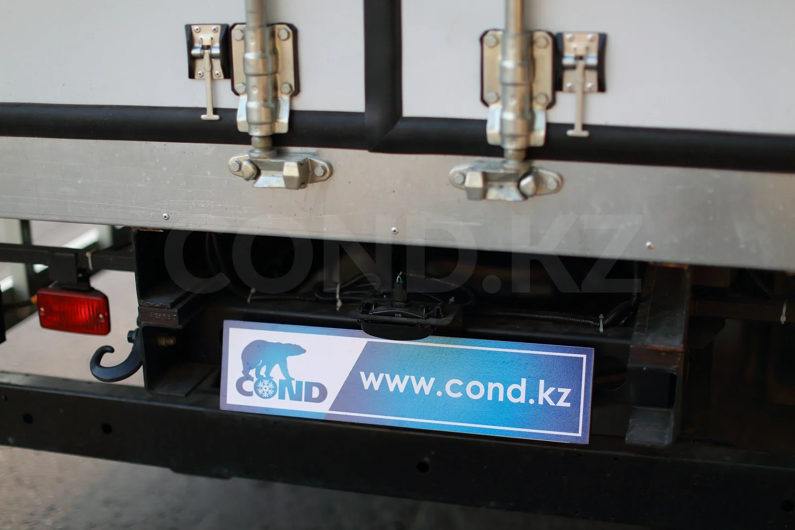 Refrigerated van on a HINO 300 with a strip curtain — cam-bar locks and the rear underrun bar — COND
